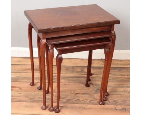 A nest of three mahogany table. Largest table being a fold over card table.  