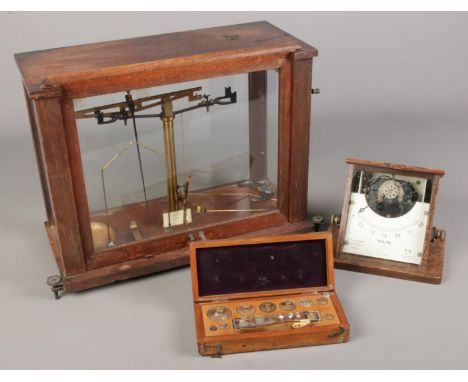 A Griffin and Tatlock voltmeter and chemist scales with weights.  