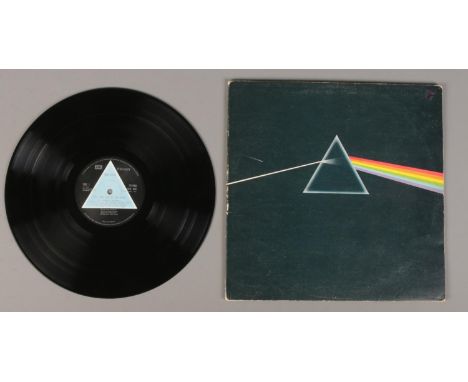 A Pink Floyd Dark Side of the Moon LP record, first pressing with solid light blue triangle label.  No posters. Some scratche