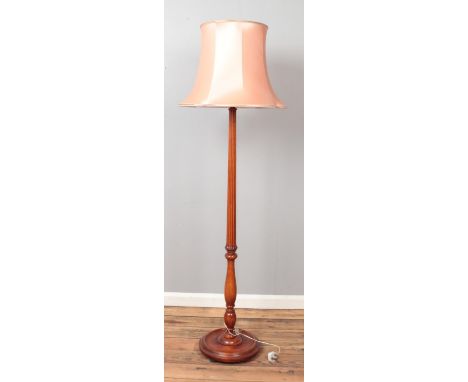 A mahogany standard lamp with reeded and turned column.  