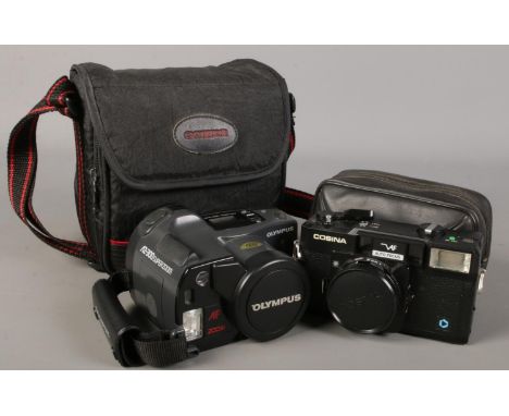 An Olympus AZ-300 Super Zoom camera along with a Cosina auto focus camera.  