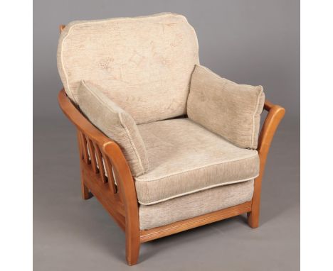 A large light oak armchair. With cream upholstery.  