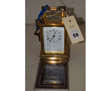 A brass carriage clock by Matthew Norman, roman enamel dial, with guarantee.