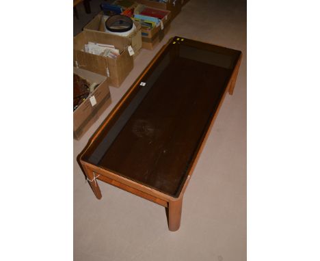 A modern light stained wood smokey glass top coffee table, the legs joined by undertier, 112cms wide.