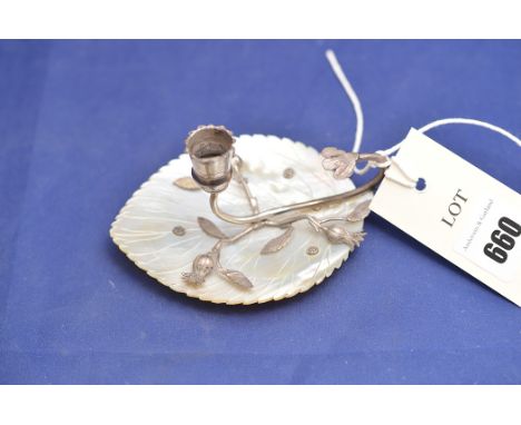 A white metal and mother-of-pearl candlestick, the carved tray in the form of a leaf, thistle pattern decoration.