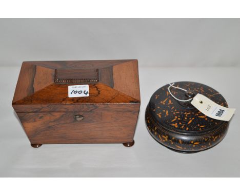 A Victorian rosewood sarcophagus-shaped tea caddy, raised on bun feet; and a turned circular ebonised dish and cover with flo