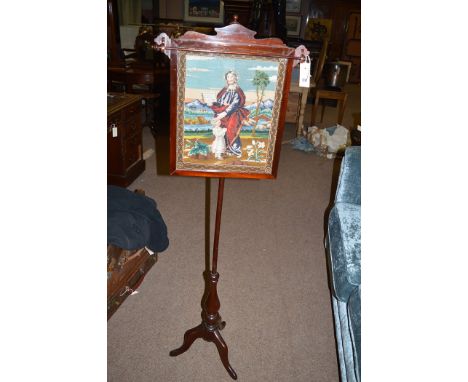 A Victorian mahogany pole screen, woolwork tapestry depicting Jesus and a child to panel.
