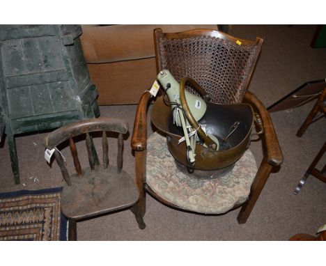 A stained wood easy chair with cane back; a child's chair; a green painted anglepoise lamp; and a brass coal scuttle.