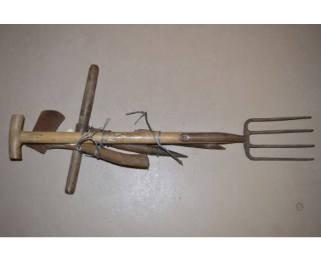 Garden tools, to include: a fork; an axe; and two others.