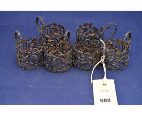 A set of six Edward VII silver chocolate cup holders, by William Hutton & Sons Ltd., London 1903, decorated with putti in a c