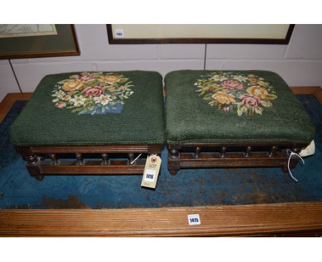A pair of late 19th Century mahogany footstools, upholstered in woolwork tapestry.