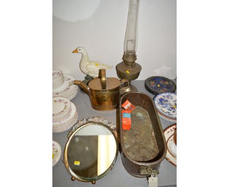 A large Aylesbury duck doorstop; a brass oil lamp; a brass watering can; a copper planter; and a mirror.