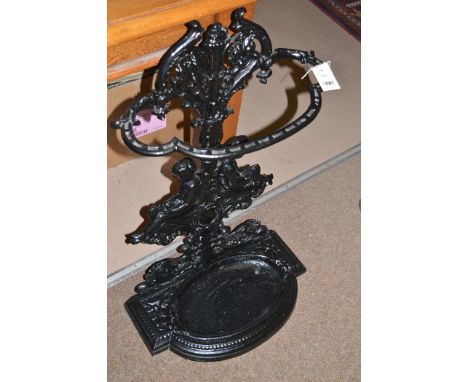 A Victorian cast metal stick/umbrella stand, with lift-out tray, putti decoration.