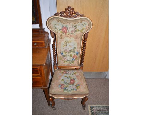 A Victorian walnut hall chair barley twist supports the back and seat upholstered in woolwork tapestry terminating in ceramic