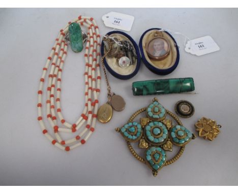 A yellow metal Indian style flower locket and two other lockets, an orange and white coral bead necklace, a malachite brooch,