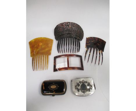 A tortoiseshell hair comb, two other combs and a buckle together with a tortoiseshell and pique work purse and a mother of pe