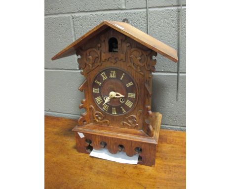 An oak case two train cuckoo clock 42cm high  