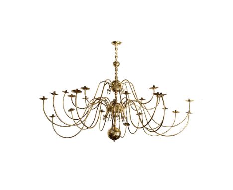 A BRASS CHANDELIER The central column comprising four globes suspended on a baluster-shaped stem, supporting fifteen scrollin