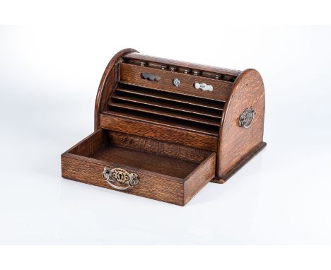 A MAHOGANY STATIONERY BOX The curved rolling lid with graduating stationary compartments and drawer with day and date manual 