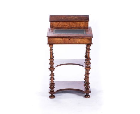 A VICTORIAN WALNUT CANTERBURY ETAGERE The serpentine top surmounted with urn finials, four carved, pierced and scrolling divi