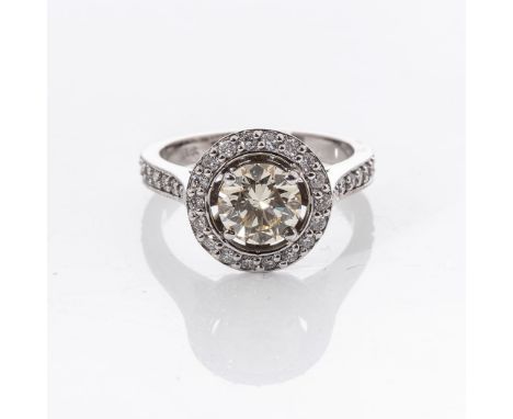A DIAMOND DRESS RING Claw-set to the centre with a natural fancy light yellow diamond weight 1,37ct, clarity VVS1, accompanie