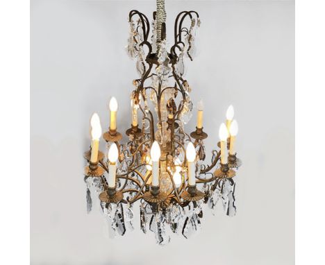 A METAL AND CRYSTAL TEN LIGHT CHANDELIER Each sconce on scrolling arms, suspended with crystal drops 
