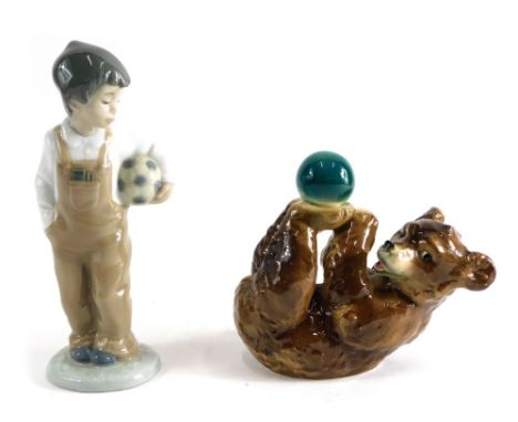 A Goebel Hummel bear and ball figure, marked beneath, 12cm high, and a Nao figure of a child holding football.