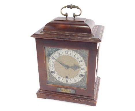 A 20thC caddy top chiming mantel clock, with Arabic and Roman numeric chapter ring and raised spandrels, in a plain case, on 