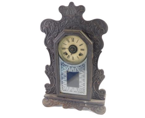 A late 19thC American oak Ansonia gingerbread mantel clock, with 13cm diameter Roman numeric dial, fitted in a heavily carved