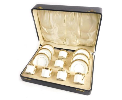 A 20thC cased Cauldon bone china coffee service, plainly decorated with a Greek key pattern on gilt and white ground, compris
