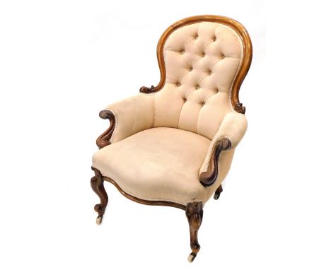 A 19thC mahogany show frame button back armchair, with shaped scroll arms, serpentine front, inverted cabriole legs terminati