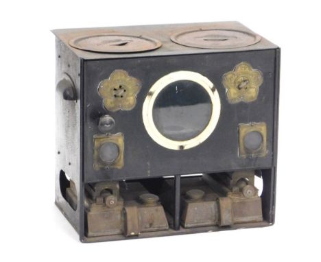 An early 20thC Rippingilles patent no. 360 portable stove, with black tinplate body, twin hobs, hinged door and twin burners,