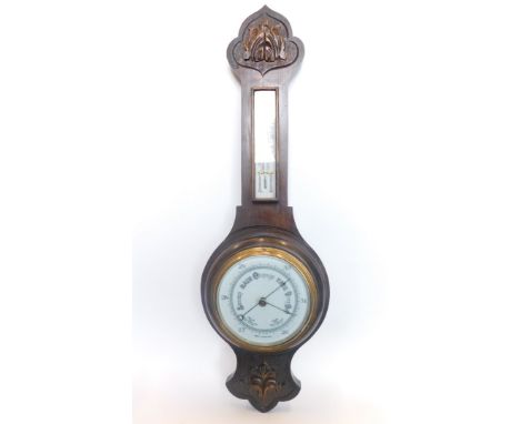 A 20thC two dial oak cased banjo barometer thermometer, with 16cm diameter main dial in a heavily carved case set with scroll