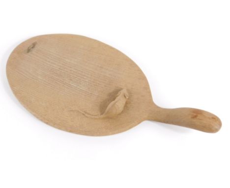 A Robert Thompson of Kilburn Mouseman oak cheeseboard, of oval form with shaped handle, carved with mouse, 37cm long.