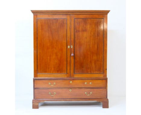 George III mahogany linen press, circa 1770, having a dentil cornice over two recessed panel doors, opening to hanging space,
