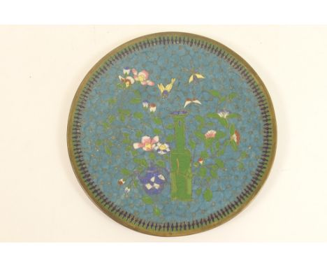 Chinese cloisonne shallow dish, worked with a vase, teapot and flowers in colours against a blue ground, 18cm diameter