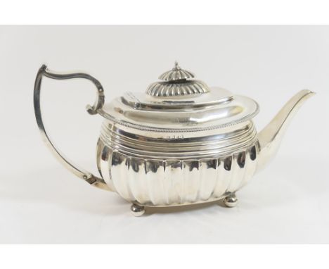 George III silver teapot, maker C F, London 1813, fluted bombe form with hinged cover, silver handle and raised on four ball 