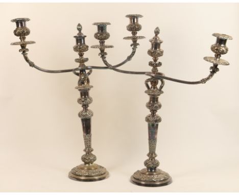 Pair of Victorian silver plated candelabra, circa 1860, having two branches centred with a sconce with flame finial candle sn