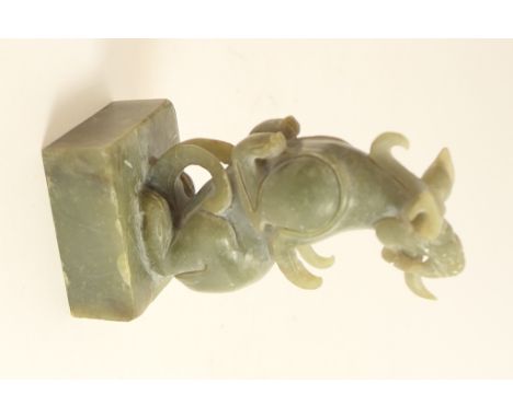 Chinese carved jade seal in the form of a mythical beast, the base incised with archaic Chinese characters, height 9.5cm