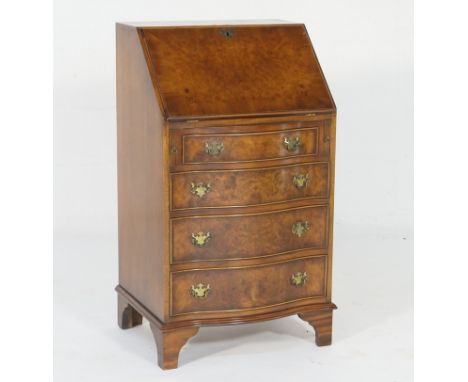 Reproduction burr walnut bureau of small proportions, crossbanded slope front opening to pigeonholes and a single drawer, ove