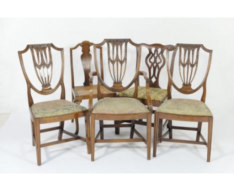 Three Sheraton Revival mahogany dining chairs, late 19th Century, comprising one carver and two singles, with shield shaped b