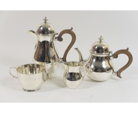 George VI silver four piece tea service in the Queen Anne Revival style, London 1939/40, lidded teapot and hot water jug with