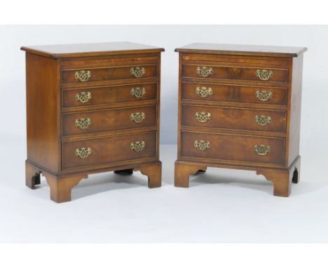 Pair of quality reproduction mahogany and walnut bachelor's chests, each having quarter veneers to the top within a feather a