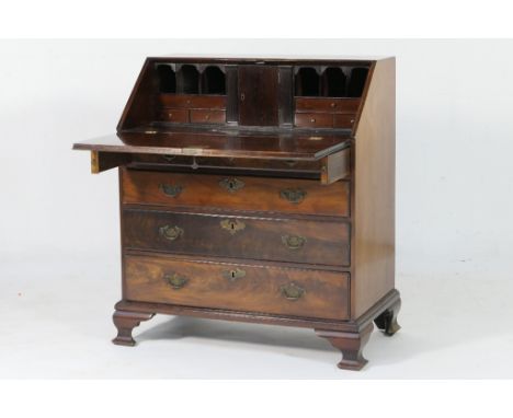 Late George III mahogany bureau, circa 1820, slope front opening to an interior with two secret drawers, central cupboard doo