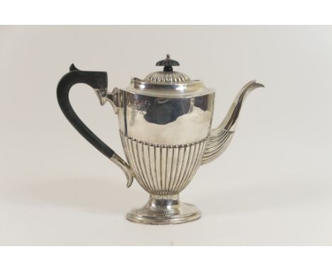 George V silver coffee pot, Chester 1915, in Regency style of half reeded oval section with hinged cover, ebony finial and ha
