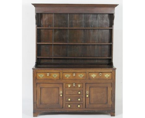 Early 19th Century oak dresser, North Wales, circa 1810-30, the top with an ogee moulded cornice over a boarded plate rack wi