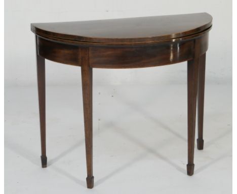 George III mahogany demi-lune folding card table, circa 1800, the folding top crossbanded with rosewood, with a green baize p
