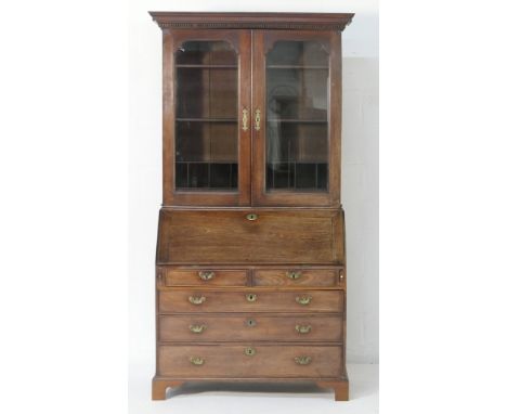 George III mahogany bureau bookcase, circa 1780, moulded dentil cornice over two bevelled glass doors opening to adjustable s