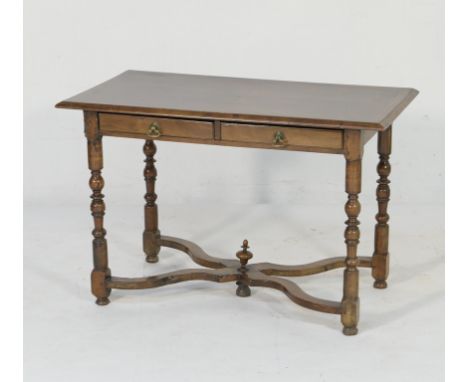 Walnut centre table, in part late 17th Century, the top quarter veneered and with feather banding over a frieze fitted with t