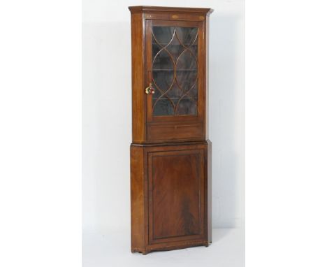 George III mahogany and inlaid free standing corner display cabinet, circa 1800, having a moulded cornice with frieze inlaid 